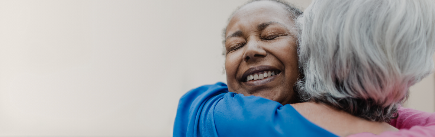 carepartners sharing a hug